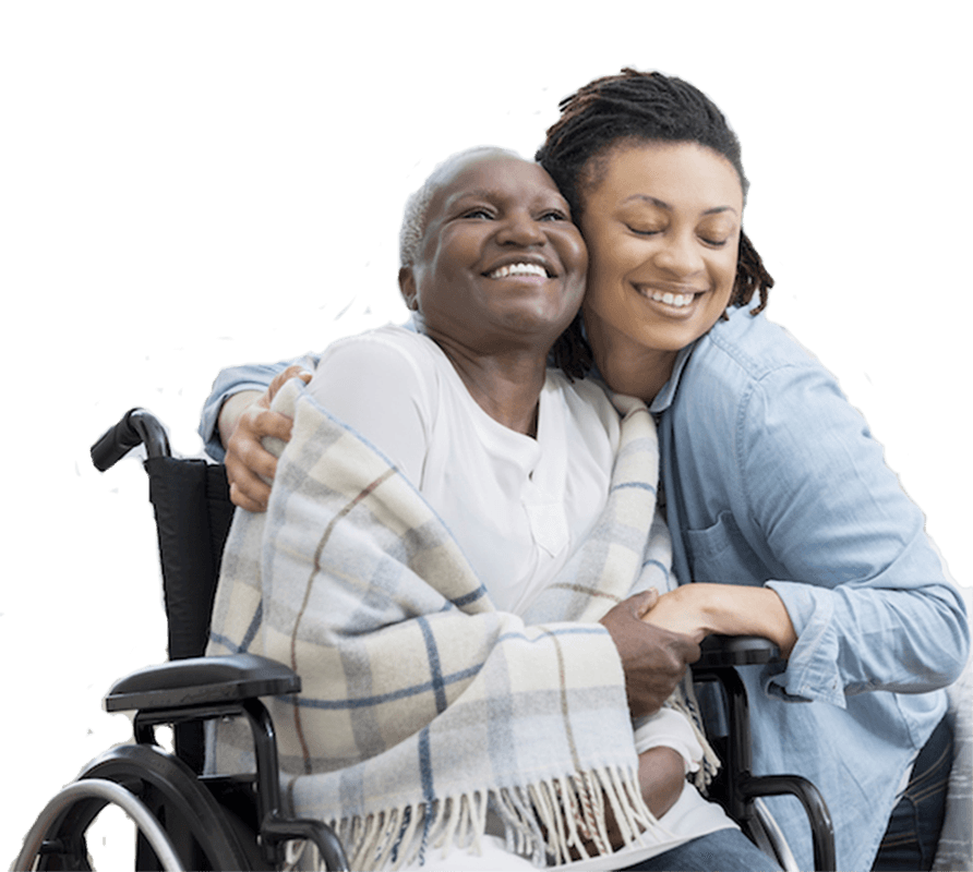 Caregiver hugging a senior in a wheelchair
